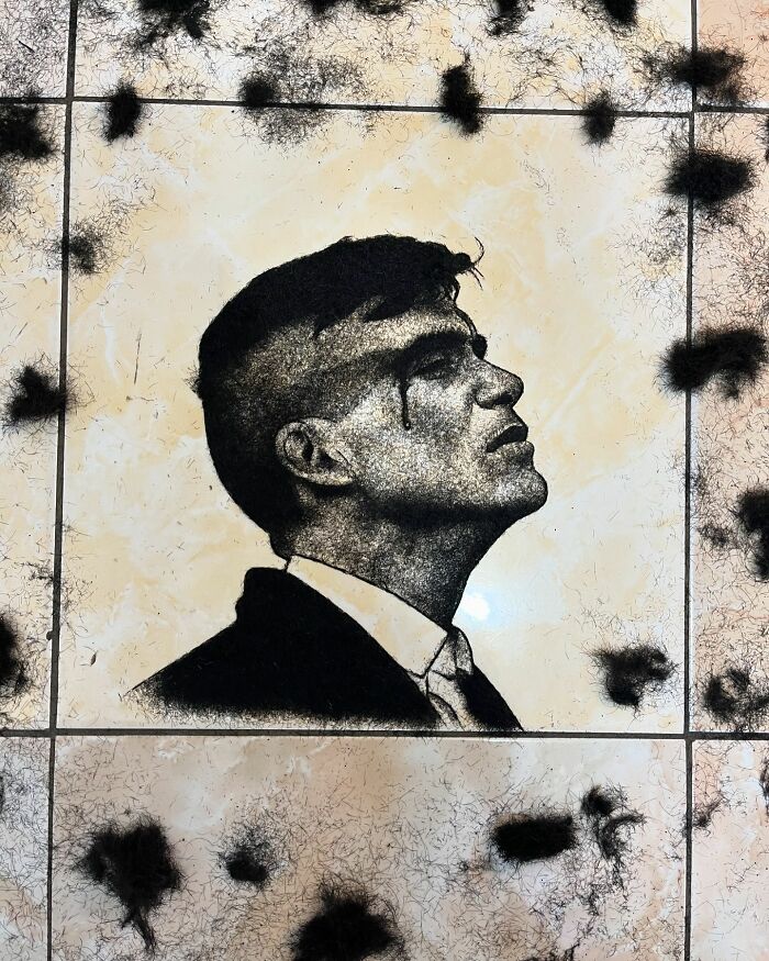 Unique portrait of a man made using cut hair on a tiled floor.