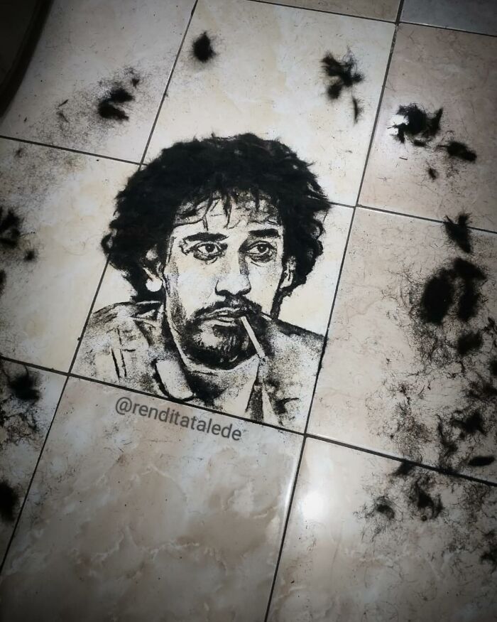 Creative barber's unique portrait made from cut hair on floor tiles.
