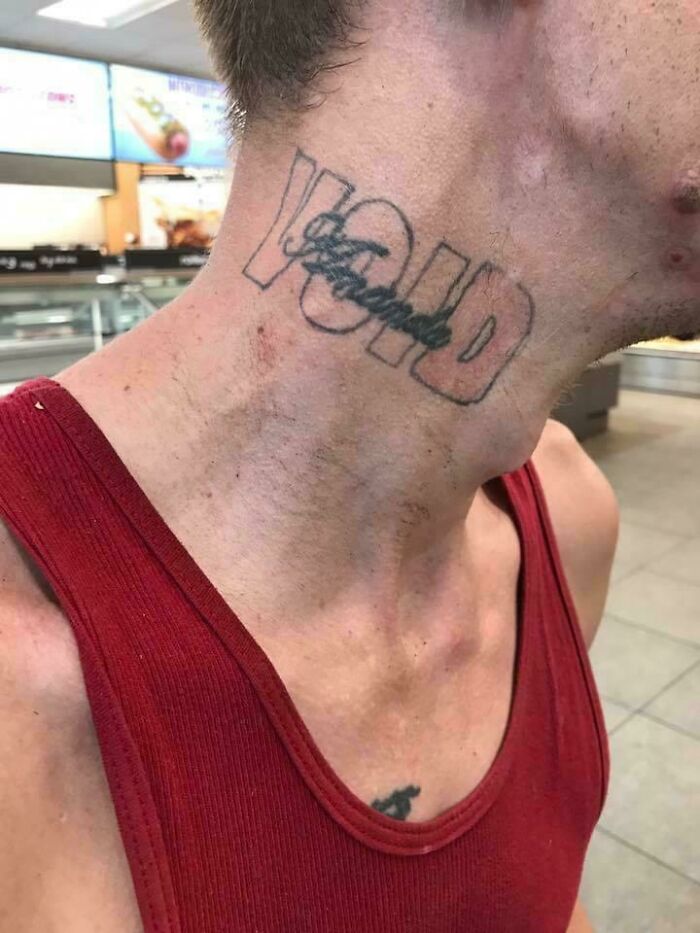 Neck tattoo reading "VOID" with crossed-out text underneath, showcasing a funny worst tattoo fail.