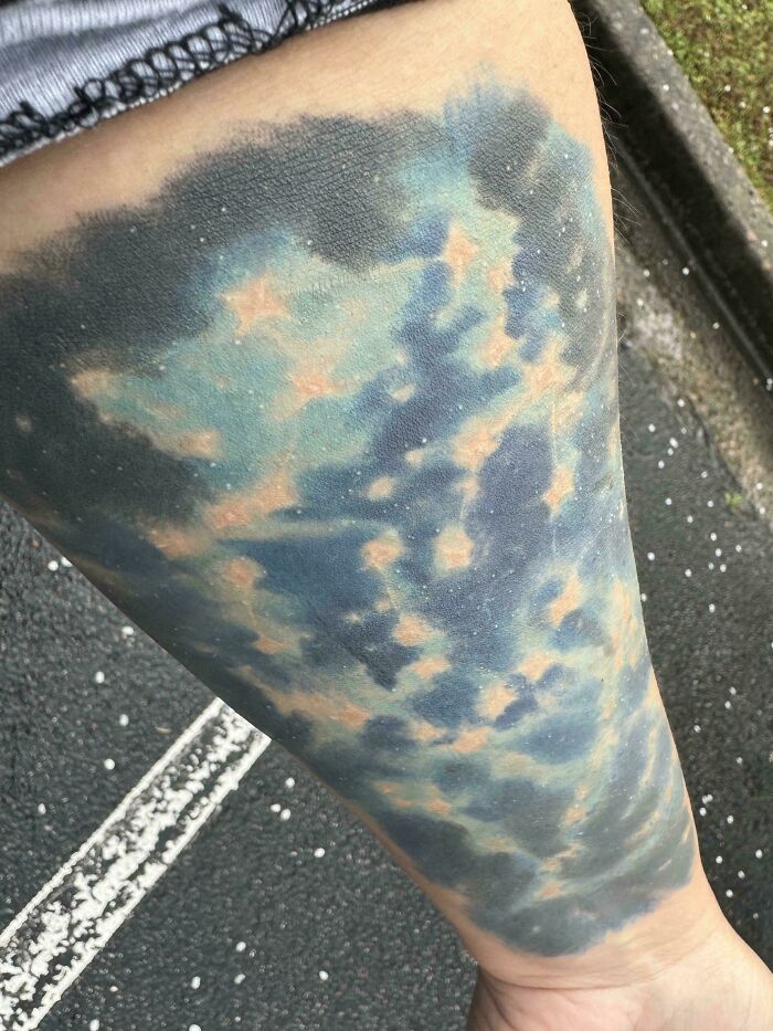 Blurry colorful tattoo on leg, showcasing funny worst tattoo fails with abstract design.