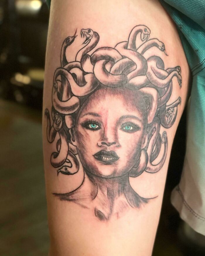Medusa tattoo with snake hair, featuring green eyes, as an example of worst tattoo fails.