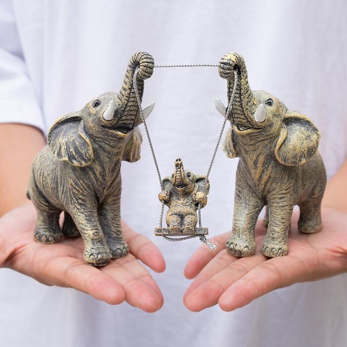 Elephant figurines holding a swing, a unique gift idea for teachers.