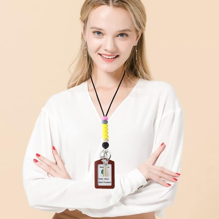 Woman wearing a lanyard with a colorful beaded keychain, ideal gift for teachers.
