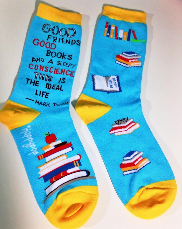 Book-themed socks for teachers with colorful book designs and a Mark Twain quote.