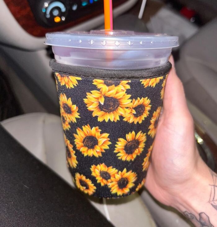 Sunflower-patterned drink sleeve held in a hand, ideal for last-minute stocking stuffers.