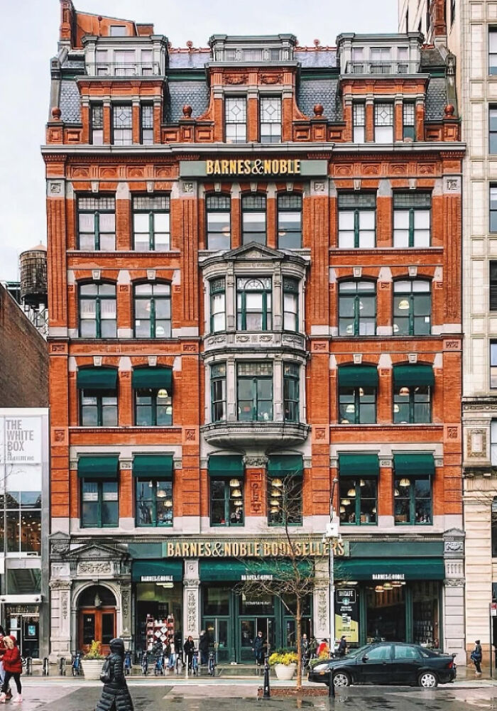 Historic red brick Barnes & Noble building featuring impressive architectural feats and detailed window designs in an urban setting.