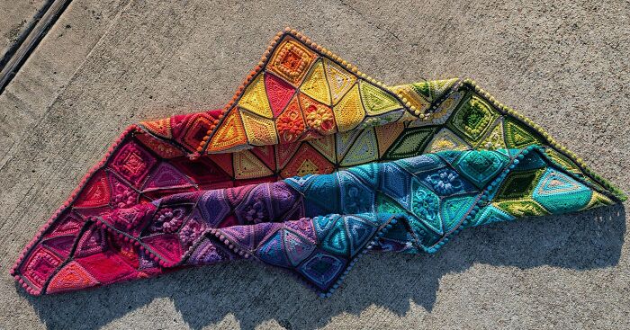 Colorful crochet blanket featuring vibrant rainbow squares, showcasing proud crochet enthusiasts' intricate handmade projects.
