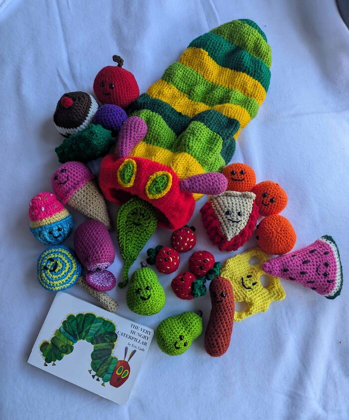 Colorful crochet fruits and vegetables inspired by The Very Hungry Caterpillar, showcasing proud crochet enthusiasts' creative projects.
