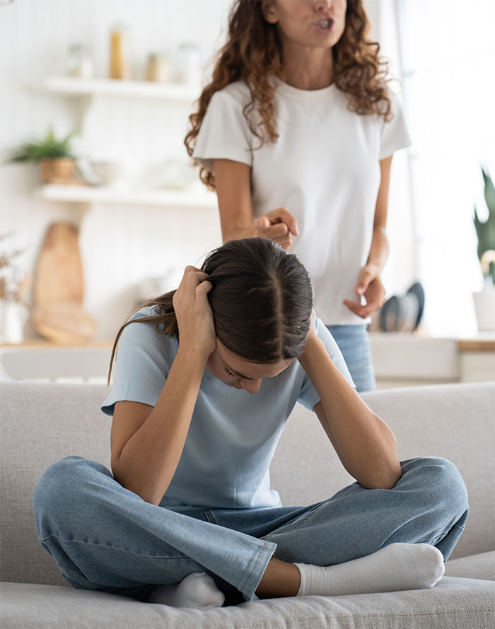 Mother insists daughter do chores despite illness; emotional family moment on a couch. Mother insists daughter do chores despite illness; emotional family moment on a couch.