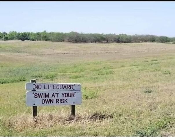 Weird sign in a field: "No lifeguard, swim at your own risk."