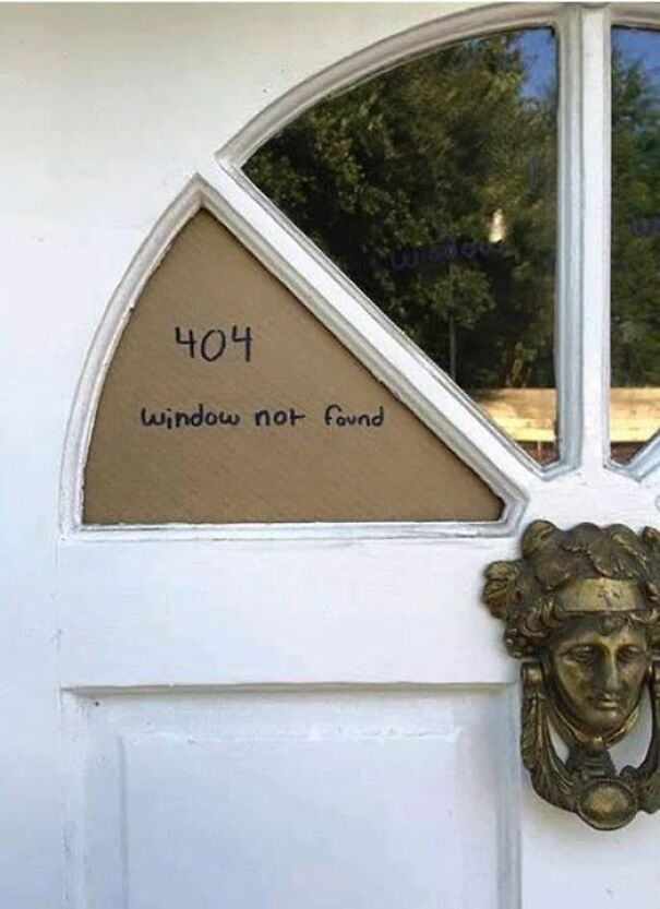 Absurd sign on a door reads "404 window not found" in one triangular pane, mimicking a computer error message.