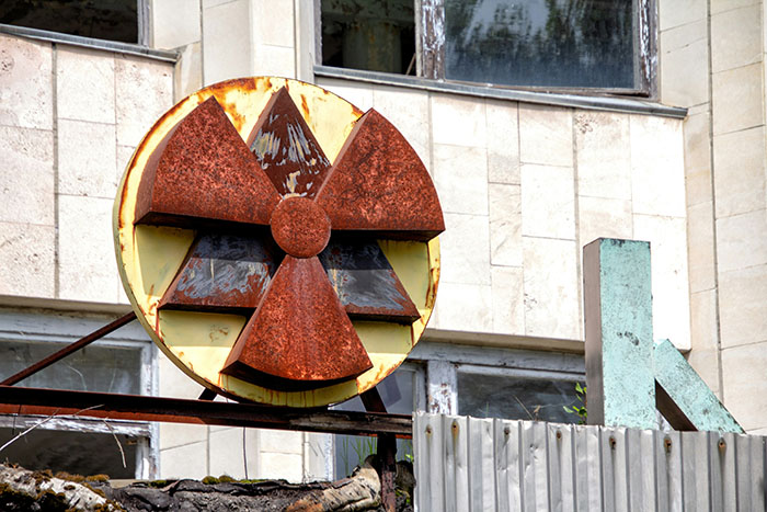Rusty radioactive symbol near Chornobyl, highlighting genetic differences in dogs from the area. Rusty radioactive symbol near Chornobyl, highlighting genetic differences in dogs from the area.
