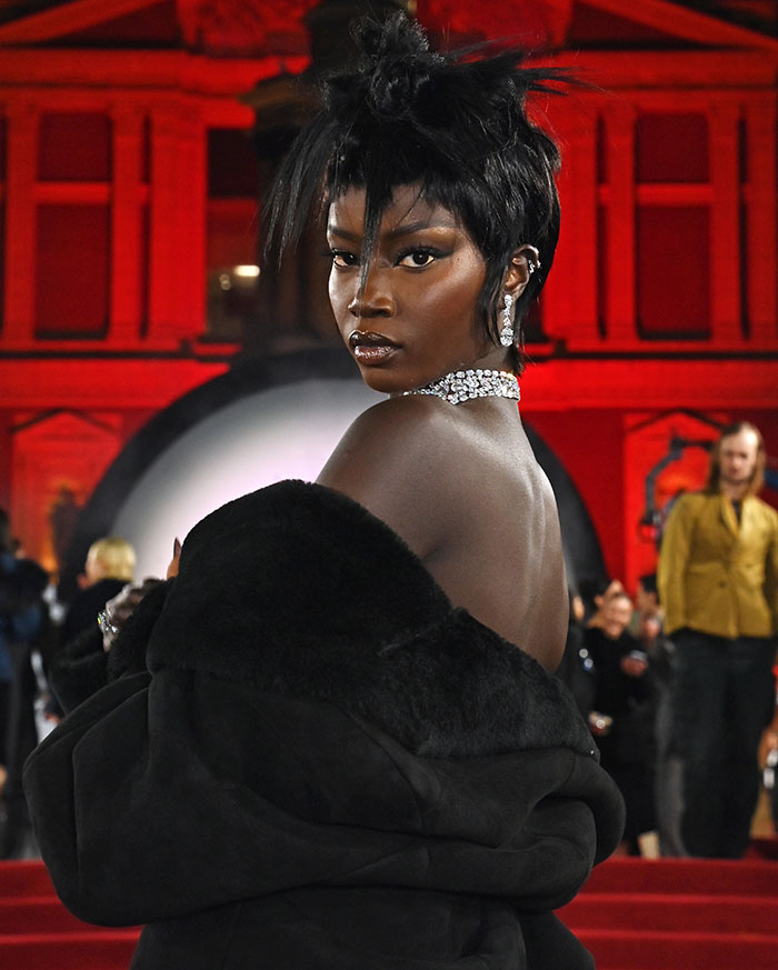 Anok Yai, black model in elegant attire at a British Fashion Awards event, competing for Model of the Year award. Anok Yai, black model in elegant attire at a British Fashion Awards event, competing for Model of the Year award.