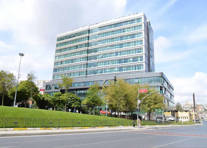 Exterior shot of Avrasya Hospital under a blue sky. Exterior shot of Avrasya Hospital under a blue sky.