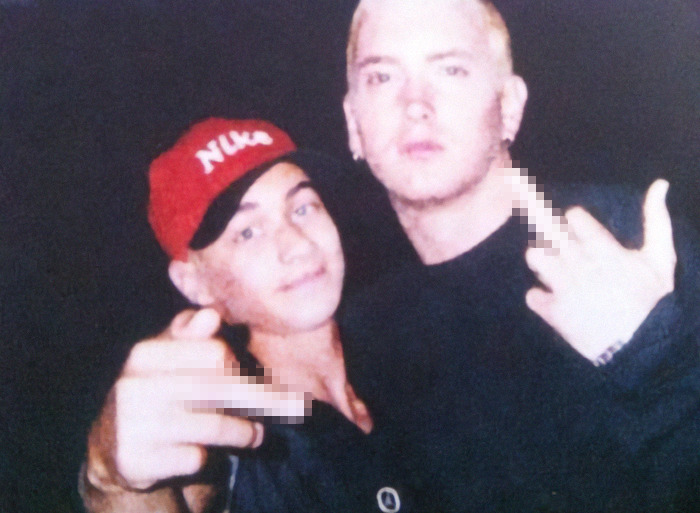 Two men posing together, one wearing a red cap, expressing emotions after mother's passing due to cancer. Two men posing together, one wearing a red cap, expressing emotions after mother's passing due to cancer.