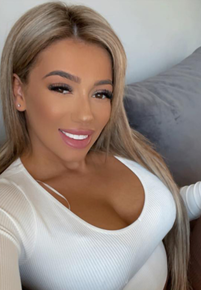 Demi Agoglia in white top smiling, linked to barbaric BBL surgery incident. Demi Agoglia in white top smiling, linked to barbaric BBL surgery incident.