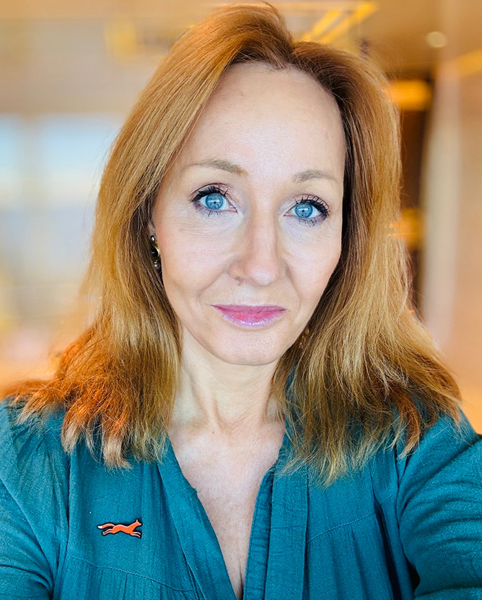 Woman with blue eyes and red hair in a teal shirt, related to objections to a New York Times article. Woman with blue eyes and red hair in a teal shirt, related to objections to a New York Times article.