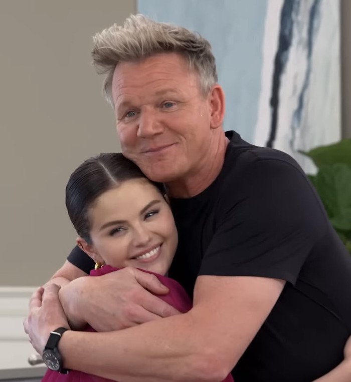 Chef Gordon Ramsay hugging Selena Gomez in a cozy setting. Chef Gordon Ramsay hugging Selena Gomez in a cozy setting.