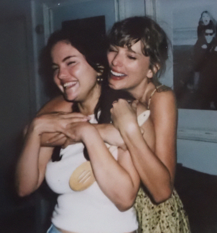 Selena Gomez and Taylor Swift smiling and hugging in casual setting. Selena Gomez and Taylor Swift smiling and hugging in casual setting.