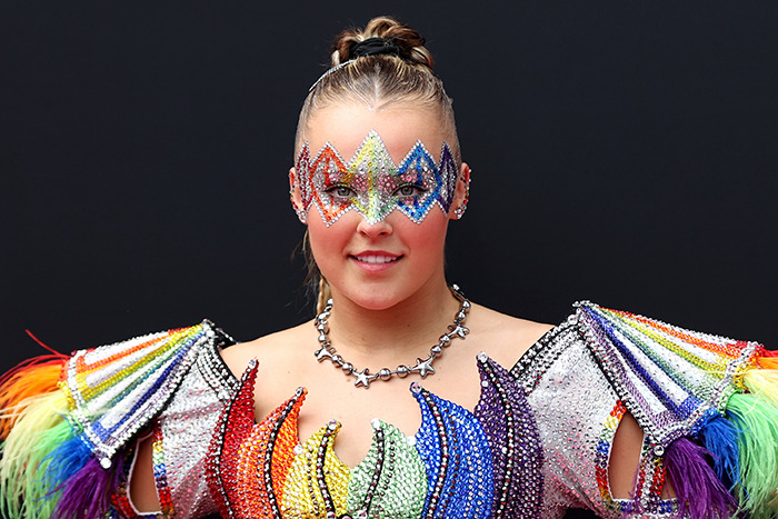 JoJo Siwa in a colorful costume at an event, related to the celebrity “Ignore List” trend. JoJo Siwa in a colorful costume at an event, related to the celebrity “Ignore List” trend.