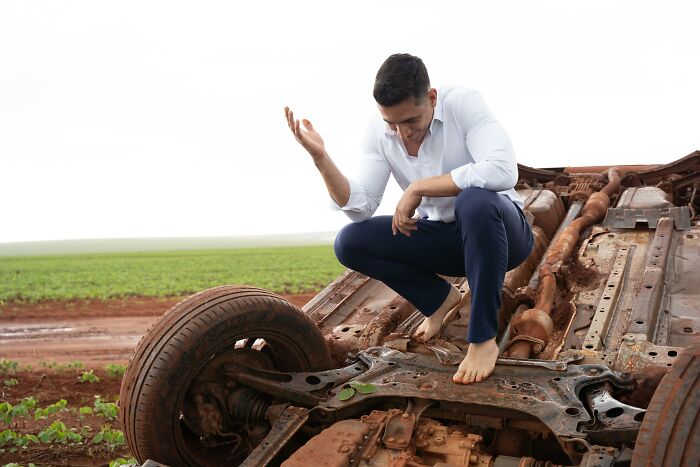 Couple takes photos at accident scene with overturned car during photo shoot trip. Couple takes photos at accident scene with overturned car during photo shoot trip.