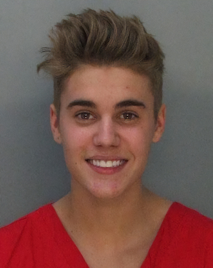 Justin Bieber wearing a red shirt in a mugshot, representing viral criminal heartthrobs. Justin Bieber wearing a red shirt in a mugshot, representing viral criminal heartthrobs.