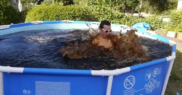 Man-takes-a-Bath-in-a-Giant-1500-Gallon-Coca-Cola-Swimming-Pool-then-adds-Mentoes.jpg