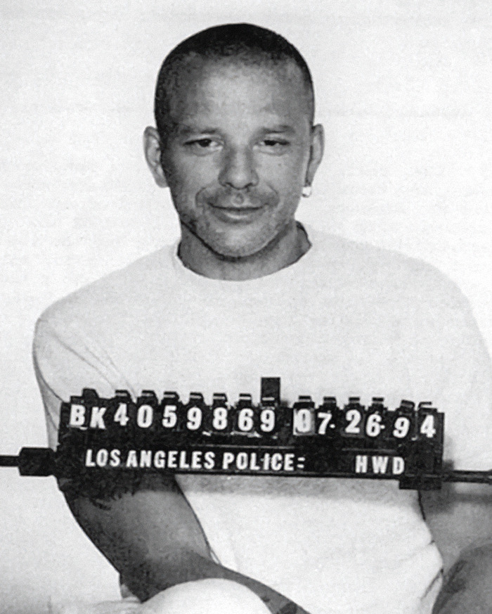 Mugshot of Mickey Rourke in a white shirt, smiling slightly, holding a Los Angeles Police sign, showcasing a viral criminal heartthrob. Mugshot of Mickey Rourke in a white shirt, smiling slightly, holding a Los Angeles Police sign, showcasing a viral criminal heartthrob.