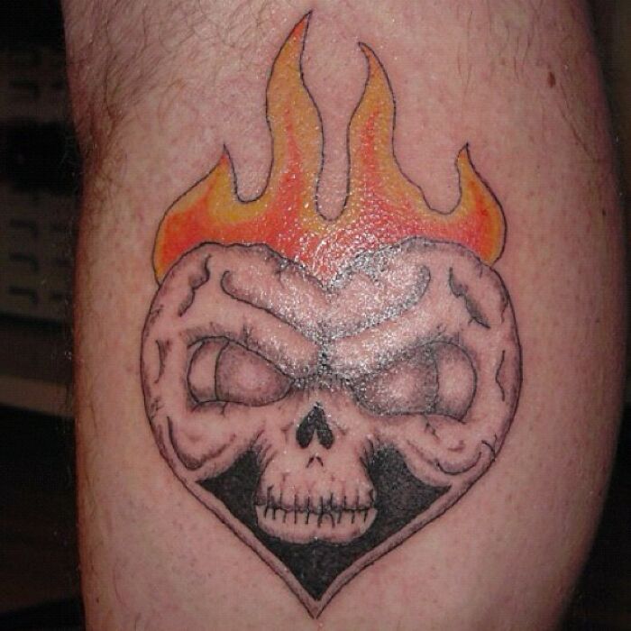 Close-up of a tattoo fail featuring a skull with flames in a heart shape.