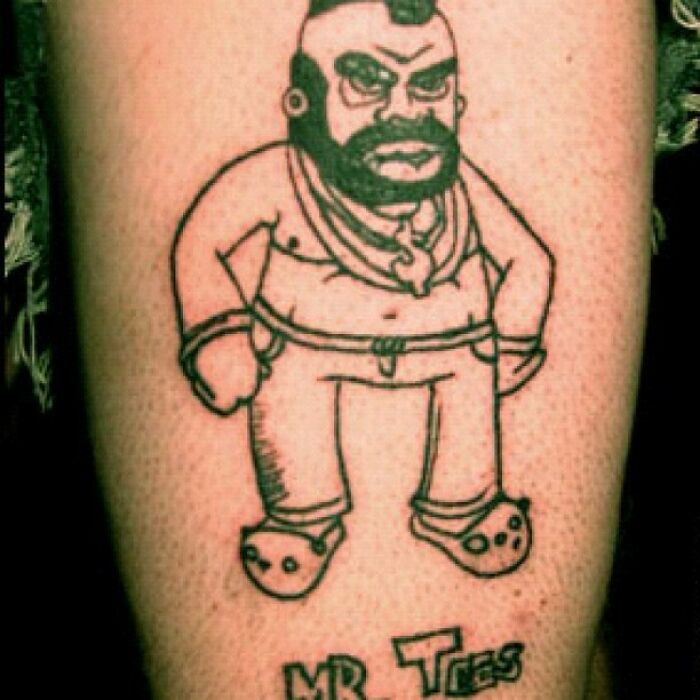 Cartoon character tattoo featuring a man in Crocs labeled "Mr Tees," illustrating a funny worst tattoo fail.