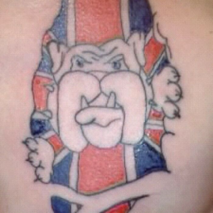 A poorly drawn bulldog tattoo with Union Jack colors, illustrating a funny worst tattoo fail.