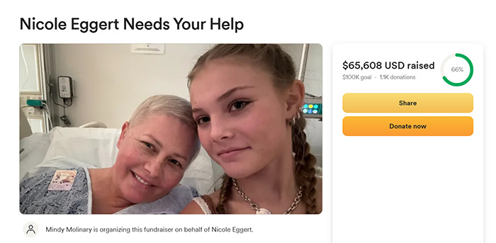 Nicole Eggert in a hospital bed smiling with a young girl, fundraising for cancer diagnosis support. Nicole Eggert in a hospital bed smiling with a young girl, fundraising for cancer diagnosis support.
