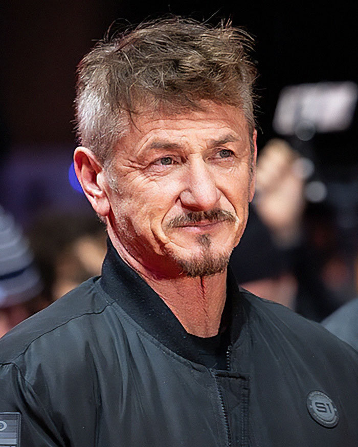 Sean Penn in a black jacket on the red carpet event, smiling. Sean Penn in a black jacket on the red carpet event, smiling.
