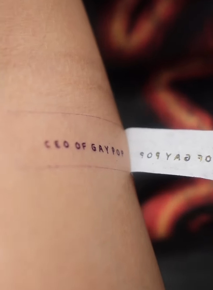 JoJo Siwa's new tattoo reading "CEO OF GAY POP" on arm, creating backlash and discussion. JoJo Siwa's new tattoo reading "CEO OF GAY POP" on arm, creating backlash and discussion.
