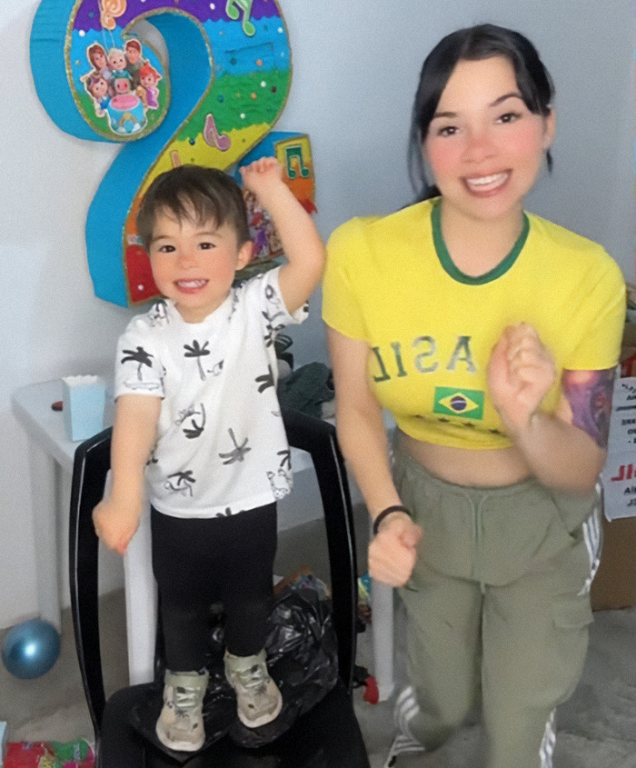Nebrazkha and her child smiling in front of colorful birthday decorations, celebrating with joy. Nebrazkha and her child smiling in front of colorful birthday decorations, celebrating with joy.