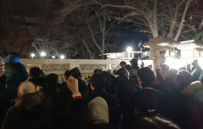 Crowd gathers in South Korea at night after martial law rejection by parliament, highlighting political tension. Crowd gathers in South Korea at night after martial law rejection by parliament, highlighting political tension.