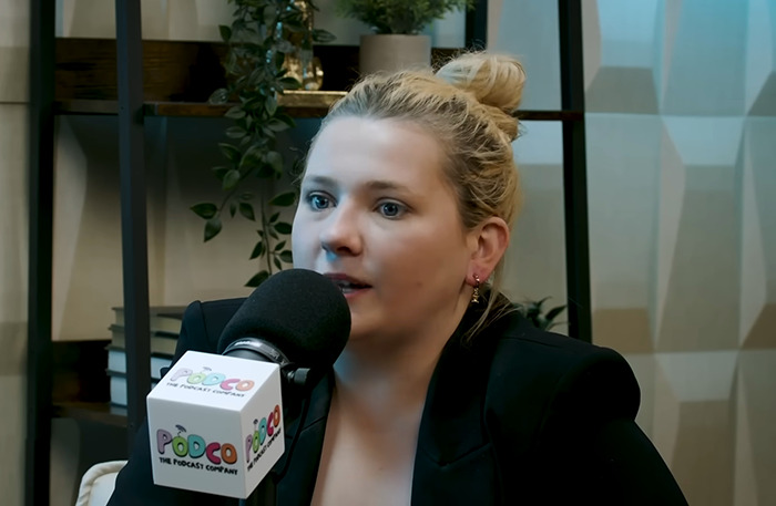 Abigail Breslin speaking into a microphone during a podcast recording. Abigail Breslin speaking into a microphone during a podcast recording.