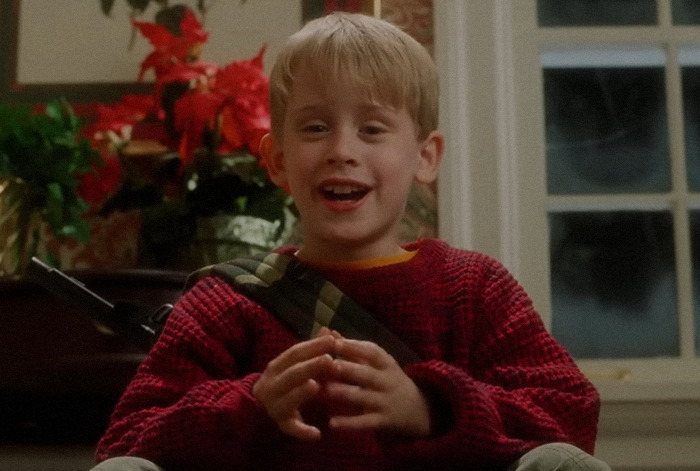 Kevin McCallister in a red sweater smiling inside a large, festive home, linked to theories about affording a huge mansion. Kevin McCallister in a red sweater smiling inside a large, festive home, linked to theories about affording a huge mansion.