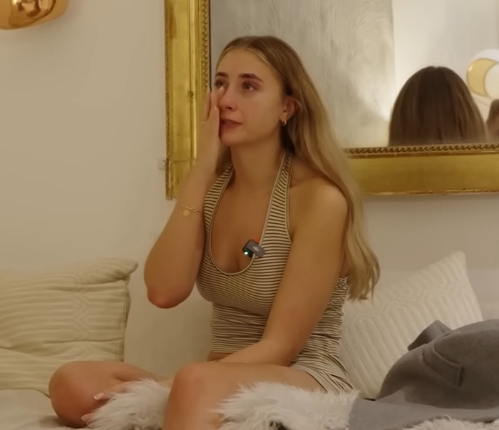 Model Lily Phillips in emotional breakdown, sitting on a bed and wiping tears from her eyes. Model Lily Phillips in emotional breakdown, sitting on a bed and wiping tears from her eyes.