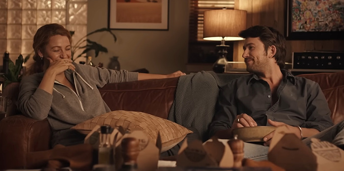 Blake Lively and her co-star Brandon Sklenar share a candid moment on a cozy couch, surrounded by soft lighting in a scene from "It Ends With Us. Blake Lively and her co-star Brandon Sklenar share a candid moment on a cozy couch, surrounded by soft lighting in a scene from "It Ends With Us.