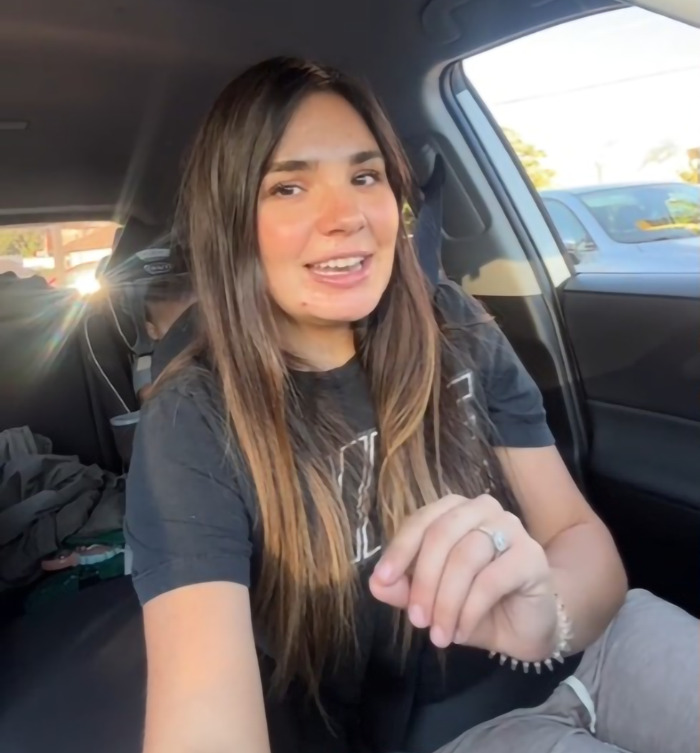 Momfluencer in a car, discussing a viral video involving her son and dad. Momfluencer in a car, discussing a viral video involving her son and dad.