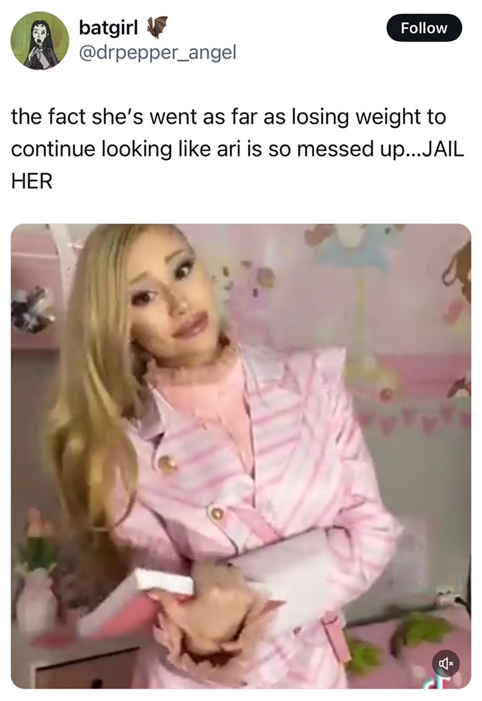 Ariana Grande impersonator posing in pink outfit, facing criticism for weight loss to resemble her. Ariana Grande impersonator posing in pink outfit, facing criticism for weight loss to resemble her.