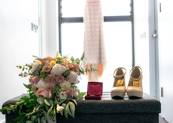 Bouquet, shoes, and dress by the window, symbolizing a wedding with keywords: attempt, bride, wedding date. Bouquet, shoes, and dress by the window, symbolizing a wedding with keywords: attempt, bride, wedding date.