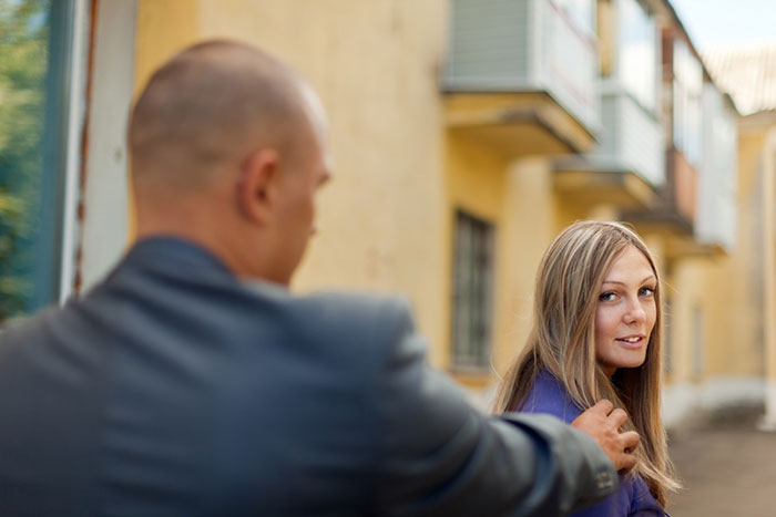Man confronting an employee outside a building. Man confronting an employee outside a building.