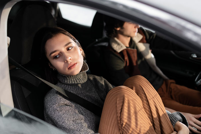 Woman in car looking thoughtful, planning a surprise house prank for her fiancé. Woman in car looking thoughtful, planning a surprise house prank for her fiancé.