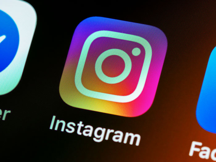 Instagram app icon on a smartphone screen, showcasing social media. Instagram app icon on a smartphone screen, showcasing social media.