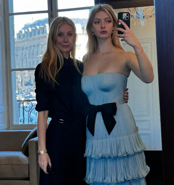 Apple Martin and mom Gwyneth Paltrow posing for a mirror selfie, one in a strapless blue dress. Apple Martin and mom Gwyneth Paltrow posing for a mirror selfie, one in a strapless blue dress.