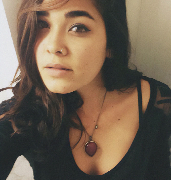 A woman with long dark hair and a necklace, possibly linked to a green card marriage scam case. A woman with long dark hair and a necklace, possibly linked to a green card marriage scam case.