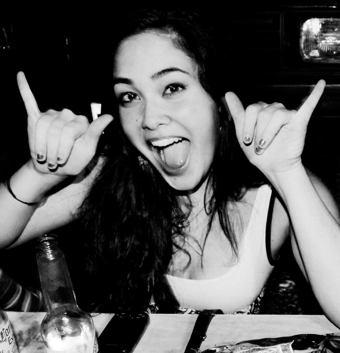 A woman smiling energetically at a table with a drink, highlighting focus on healing and new beginnings. A woman smiling energetically at a table with a drink, highlighting focus on healing and new beginnings.