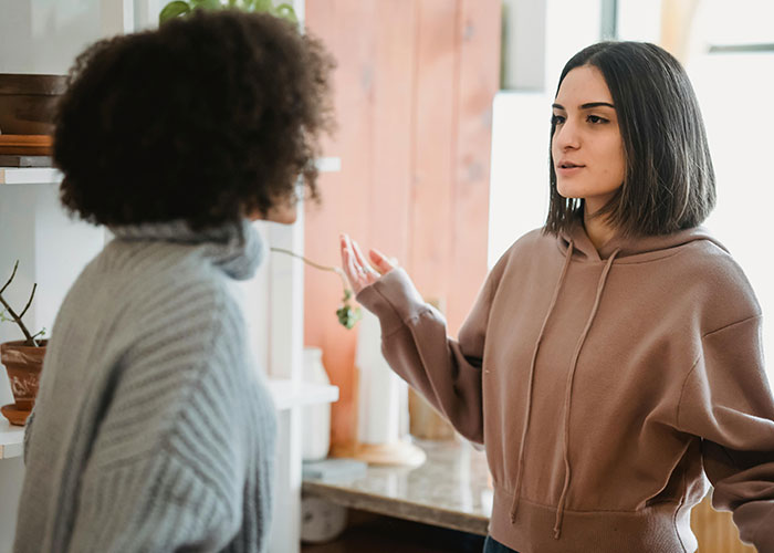 Two roommates having a serious discussion, revealing a secret that changes their dynamic. Two roommates having a serious discussion, revealing a secret that changes their dynamic.